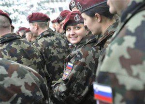 A female member of the NATO KFOR Joint Enterprise for Kosovo force speaks with another member during a farewell ceremony in Vrhnika's military barracks