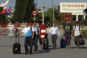 Chinese nationals cross to Cambodia from Vietnam at the Bavet international checkpoint in Svay Rieng province