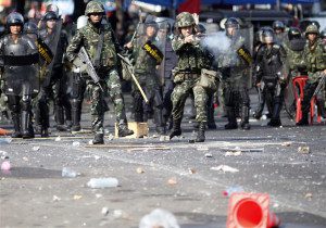 Thai soldiers fire their weapons at anti-government "red shirt" protesters during clashes in central Bangkok