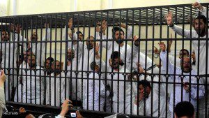 File photo of supporters of the Muslim Brotherhood and ousted President Mursi reacting in a court in Alexandria