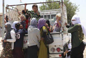 Displaced families from the minority Yazidi sect, fleeing the violence in the Iraqi town of Sinjarl west of Mosul, arrive at Dohuk province