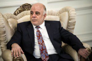 New Iraqi Prime Minister Abadi listens to U.S. Secretary of State Kerry after a meeting in Baghdad