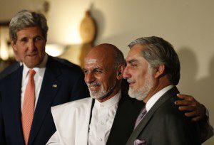 Afghan presidential candidates Ashraf Ghani Ahmadzai and Abdullah Abdullah smile next to U.S. Secretary of State John Kerry after a news conference in Kabul