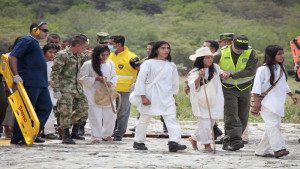 Colombian rescue workers, soldiers and police officers help to guide lightning strike victims from a helicopter at an army base in Santa Marta