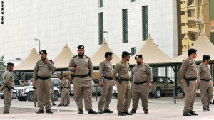 Saudi policemen stand guard in front of