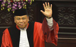 Ketua Mahkamah Konstitusi (MK) Hamdan Zoelva (kiri) dan Wakil Ketua MK Arief Hidayat (kanan) melambaikan tangan usai mengucapkan sumpah jabatan pada sidang pleno khusus di Gedung MK, Jakarta, Rabu (6/11).