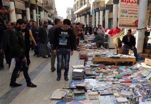Iraqis look at books on al-Mutanabi Street (AP Photo/Karim Kadim)