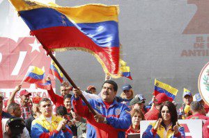 Venezuela's President Nicolas Maduro (C) waves a Venezuelan flag during a rally to commemorate the 26th anniversary of the social uprising known as 'Caracazo', which Venezuela's late President Hugo Chavez said marked the start of his revolution