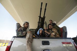 Houthi fighters ride a military truck outside the Presidential Palace in Sanaa