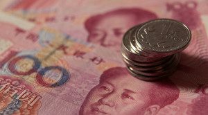 Chinese one yuan coins and 100 yuan banknotes are seen in this picture illustration taken in Beijing