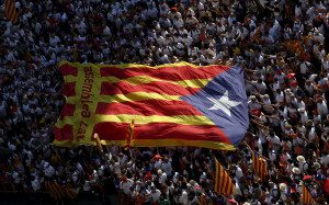 Catalan pro-independence supporters hold a giant Catalan separatist flag during a demonstration called "Via Lliure a la Republica Catalana" on Catalunya's National Day in Barcelona, Spain