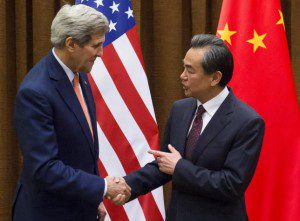 Chinese Foreign Minister Wang Yi and U.S. Secretary of State John Kerry shake hands prior to meetings at the Ministry of Foreign Affairs in Beijing