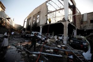 People stand at the site of an airstrike which witnesses said was by Saudi-led coalition aircraft on mourners at a hall where a wake for the father of Jalal al-Roweishan, the interior minister in the Houthi-dominated Yemeni government, was being held, in Sanaa, Yemen October 8, 2016. REUTERS/Khaled Abdullah